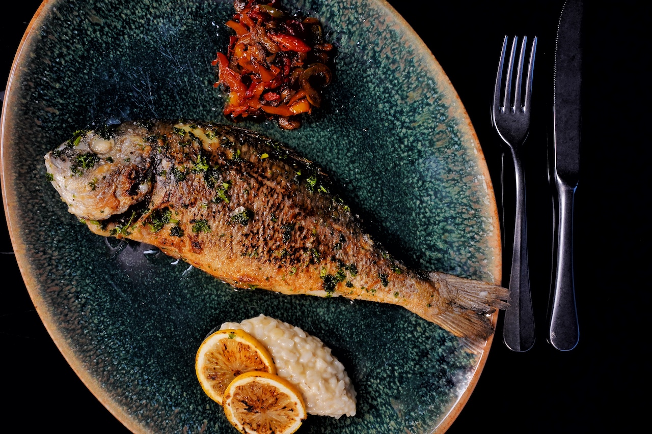 Nach dem Kochen kann der Fisch kurz auf den Grill gelegt werden. Wer die scharfe nicht direkt über den Fisch gibt, kann sie wohldosiert genießen